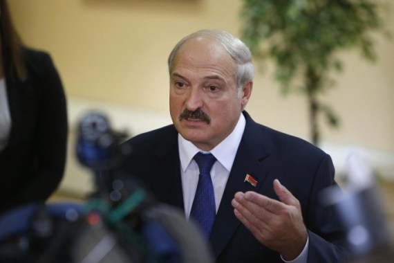 Belarusian President Alexander Lukashenko speaks to media at a polling station after voting during the presidential election in Minsk, Belarus, Sunday, Oct. 11, 2015. A presidential election was under way Sunday in Belarus, where authoritarian leader Alexander Lukashenko faced no serious competition and was expected easily to win a fifth term. The opposition called for a boycott of the vote. (AP Photo/Sergei Grits)
