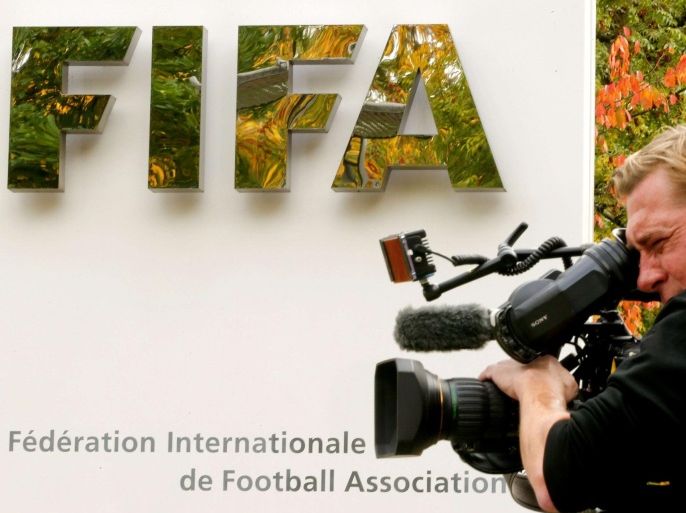 A cameraman stands in front of FIFA's headquarters in Zurich, Switzerland October 8, 2015. FIFA President Sepp Blatter and his possible successor, UEFA chief Michel Platini, have been provisionally suspended for 90 days by the global soccer body's ethics committee. REUTERS/Arnd Wiegmann