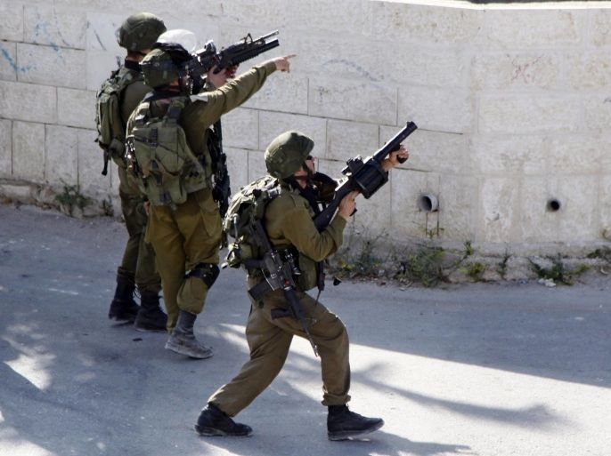Israeli soldiers clash with Palestinians, not seen, in the West Bank village of Tekoa, near Bethlehem, Thursday, Oct. 1, 2015. (AP Photo/Mahmoud Illean)