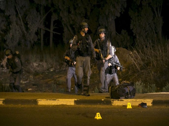 Israeli police patrol near the scene of an attack by an Arab citizen of Israel that injured four Israelis in Gan Shmuel near the central israeli town of Hadera, October 11, 2015. An Arab citizen of Israel stabbed four people at a bus stop in northern Israel on Sunday as security forces confronted a surge of attacks against Israelis in the Jewish state and in the occupied West Bank. Four Israelis and 23 Palestinians have died in 12 days of bloodshed fuelled in part by Muslim anger over increasing Jewish access to the al-Aqsa mosque compound in Jerusalem. Violence, including a series of stabbings, has spread from the holy city and the Israeli-occupied West Bank to Israel's interior and Hamas-ruled Gaza. REUTERS/Baz Ratner