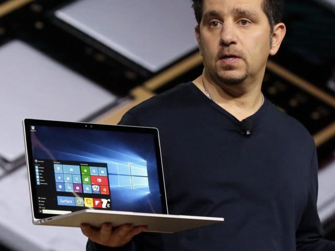 Microsoft vice president for Surface Computing Panos Panay holds a Surface Book laptop during a presentation, in New York, Tuesday, Oct. 6, 2015. Microsoft says it's for scientists, engineers and gamers who need a lot more performance than a tablet. (AP Photo/Richard Drew)