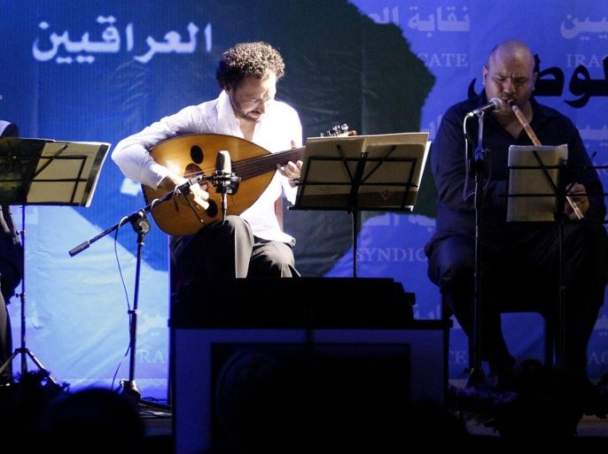 Iraqi oud player Naseer Shamma (2nd L) performs during a concert in Baghdad June 28, 2012. Many of Iraq's most talented musicians fled during the rule of Saddam Hussein, fearing persecution for their political views and suffering from a lack of funding and exposure if they refused to glorify the leader in their art. Others left after the U.S.-led invasion in 2003, escaping violence as war broke out. Concert venues were shuttered. Some musicians were threatened by the Iraqi arm of al Qaeda. Now, gingerly, some musicians are making plans to come back, hoping to revive Iraq's rich musical tradition on home soil. Picture Taken June 28, 2012. To match Feature IRAQ-MUSIC/ REUTERS/Thaier al-Sudani (IRAQ - Tags: POLITICS CIVIL UNREST ENTERTAINMENT SOCIETY)
