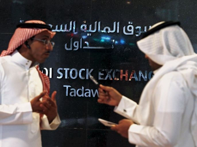 Traders talk as they monitor screens displaying stock information at the Saudi Stock Exchange (Tadawul) in Riyadh June 15, 2015. The chief executive of Saudi Arabia's stock exchange said on Monday he expected a flurry of licenses allowing the first foreign investors to buy shares there in coming weeks. To match Interview SAUDI-STOCKEXCHANGE/ REUTERS/Faisal Al Nasser