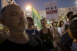 Left-wing protesters hold signs during a protest condemning Friday's arson attack in the West Bank, at Rabin square in Tel Aviv August 1, 2015. Some 3,000 demonstrators gathered for the rally organised by the Israeli anti-settler group Peace Now against the attack by suspected Jewish assailants who torched a Palestinian home in the occupied West Bank on Friday, killing an 18-month-old toddler and seriously injuring three other family members, an act that Israel's prime minister described as terrorism. REUTERS/Baz Ratner