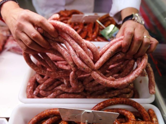 A butcher arranges pieces of sausage at his shop in Marseille, France, October 27, 2015. Eating processed meats like hot dogs, sausages and bacon can cause colorectal cancer in humans, and red meat is also a likely cause of the disease, World Health Organization (WHO) experts said. The review by WHO's International Agency for Research on Cancer (IARC), released on Monday, said additionally that there was some link between the consumption of red meat and pancreatic cancer and prostate cancer. REUTERS/Jean-Paul Pelissier