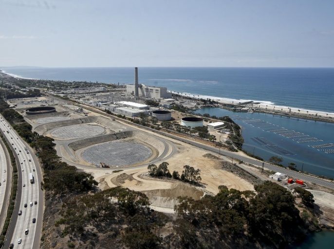 This Friday, Sept. 4, 2015 photo shows construction of the Carlsbad, Calif., desalination plant between Interstate 5 and the Pacific Ocean. Climate change and drought have stretched water supplies from coast to coast. The vast majority of 50 state water officials surveyed by the federal government expect shortages to affect them over the next 10 years. (AP Photo/Lenny Ignelzi)