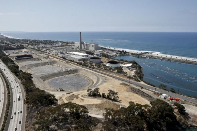 This Friday, Sept. 4, 2015 photo shows construction of the Carlsbad, Calif., desalination plant between Interstate 5 and the Pacific Ocean. Climate change and drought have stretched water supplies from coast to coast. The vast majority of 50 state water officials surveyed by the federal government expect shortages to affect them over the next 10 years. (AP Photo/Lenny Ignelzi)