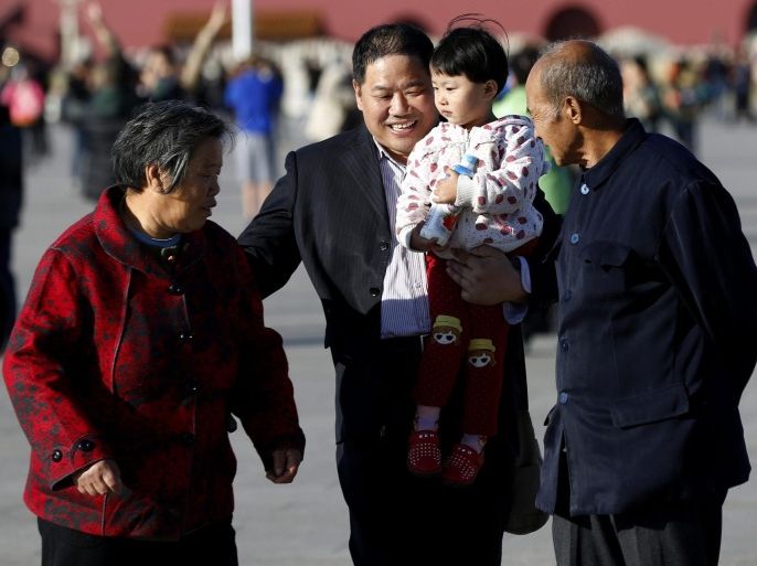 A family look after a child at Tiananmen Square in Beijing, China, 29 October 2015. China is to abolish its one-child policy, media reported from a meeting of the Central Committee of the Communist Party in Beijing.