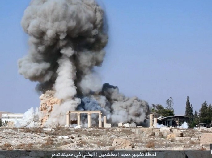 FILE - This undated file photo posted on a social media site on Aug. 25, 2015, by Islamic State militants, which has been verified and is consistent with other AP reporting, shows smoke from the detonation of the 2,000-year-old temple of Baalshamin in Syria's ancient caravan city of Palmyra. Experts, conservators and local residents are scrambling to document Syria's millennia-long cultural heritage that has been damaged by the country's war since 2011, by battles against the Islamic State group and by its intentional destruction. (Islamic State social media account via AP, File)