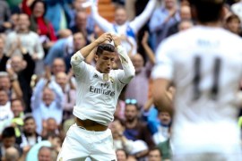 Real Madrid's Portuguese striker Cristiano Ronaldo (L) celebrates after scoring the 2-0 lead against UD Levante during the Spanish Liga Primera Division soccer match played at Santiago Bernabeu stadium, in Madrid, Spain, 17 October 2015.