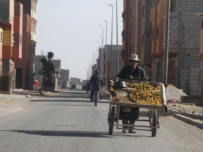 In this photo dated Dec. 10, 2013, a fruitseller pushes his wares through the streets of Laayoune, Western Sahara, where unemployment is high and most food has to be imported from Morocco. Nearly 40 years after Morocco annexed these lands unemployment runs high and there are fears that the unrest and dissatisfaction could spill over into the unstable desert lands nearby where al-Qaida holds sway. (AP Photo/Paul Schemm)
