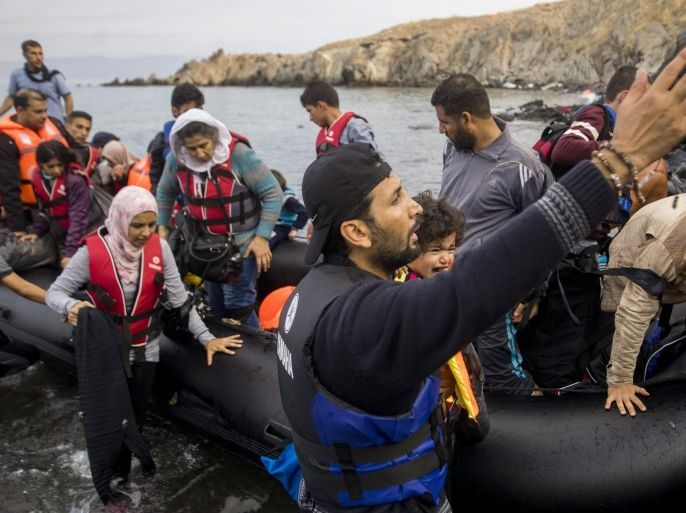 Migrants arrive with an overloaded rubber dinghy from Turkey on the coast of Lesbos island, Greece, Tuesday, Oct. 6, 2015. (Zoltan Balogh/MTI via AP)