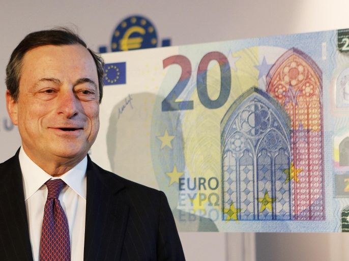 File - In this Tuesday, Feb. 24, 2015 file photo, Mario Draghi, the president of the European Central Bank, stands next to a copy of a 20 euro banknote in Frankfurt, Germany. On Thursday, Oct. 22, 2015, Draghi hinted that the bank may expand its monetary stimulus at its December meeting in order to shore up the ailing recovery in the 19-country eurozone. (AP Photo/Michael Probst, File)