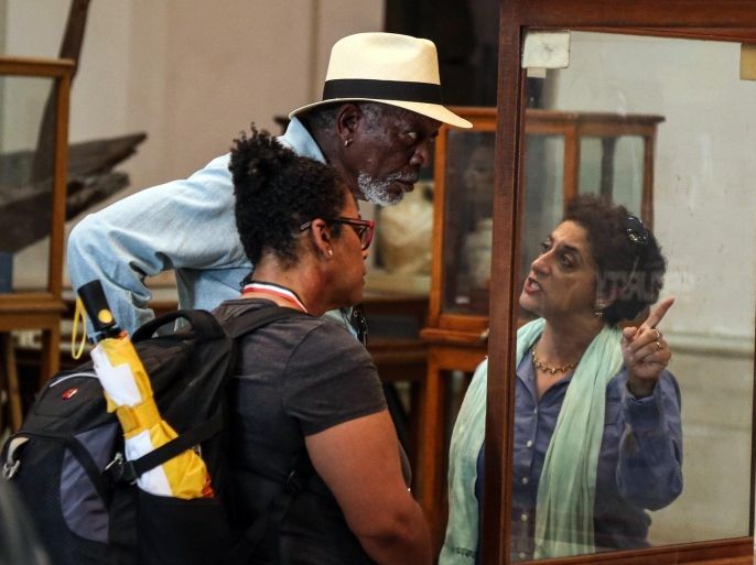 Actor Morgan Freeman listens to an Egyptologist explain an artifact during a visit to the Egyptian Museum, in Tahrir Square, Cairo, Egypt, Tuesday, Oct. 20, 2015. Freeman is in Egypt to work on a National Geographic documentary titled, "The Story of God." (AP Photo/ Mohamed El Raai)