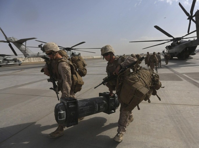 U.S. Marines arrive at Kandahar air base at the end of operations for the Marines and British combat troops in Helmand October 27, 2014. A fleet of planes and helicopters airlifted the last U.S. and British forces from a key base in southern Afghanistan on Monday, a day after the international coalition closed the massive facility and handed it over to the Afghan military. REUTERS/Omar Sobhani (AFGHANISTAN - Tags: MILITARY CONFLICT POLITICS)