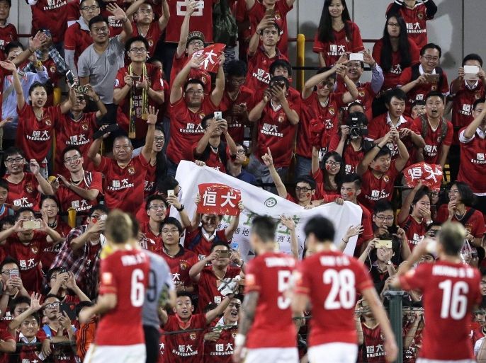 Supporters cheer for China's Guangzhou Evergrande Taobao FC players after their AFC Champions League soccer match against Japan's Kashiwa Reysol at Hitachi Kashiwa Soccer Stadium in Kashiwa, east of Tokyo, Japan, 25 August 2015. Guangzhou Evergrande Taobao FC won the match.