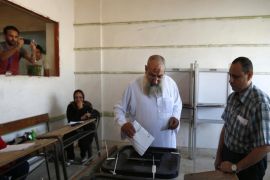 The deputy head of Egypt's Al-Nour Party cleric Yasser El-Borhamy, casts his ballot at a polling station during the first round of Egyptian parliamentary elections, at a polling station in Alexandria, Egypt, Sunday, Oct. 18, 2015. (AP Photo/Hassan Ammar)