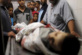 ATTENTION EDITORS - VISUAL COVERAGE OF SCENES OF INJURY OR DEATH Palestinians gather around the body of Palestinian boy Marwan Barbakh,12, who was shot dead by Israeli forces on Saturday, at a hospital morgue in Khan Younis in the southern Gaza Strip October 10, 2015. Israeli security forces on Saturday shot dead two Palestinians aged 12 and 15, one of them Barbakh, in protests along Gaza's border fence, Palestinian medics said, and Israeli police said they killed three Palestinian assailants in separate violence in Jerusalem. REUTERS/Ibraheem Abu Mustafa