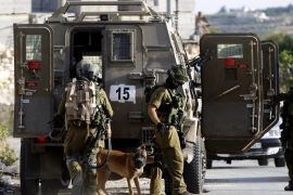 Israeli soldiers deploying with a sniffer dog in Bet Kahel, near Hebron, West Bank, 19 June 2014, as the search for three missing Israeli teenagers, presumed kidnapped, enters its seventh day. Eyal Yifrah, 19, Gilad Shaar, 16, and Naftali Frenkel, 16, were students at a Jewish seminary and were last seen late 12 June at a common hitchhike stop near the Gush Etzion settlement bloc north of Hebron. No organization has claimed responsibility for the disappearance, which Israel blames on the Palestinian Islamist movement Hamas. Since the beginning of the operation about 300 activists were arrested, including 200 members of Hamas, and 900 army buildings have been scanned, spokesman said.