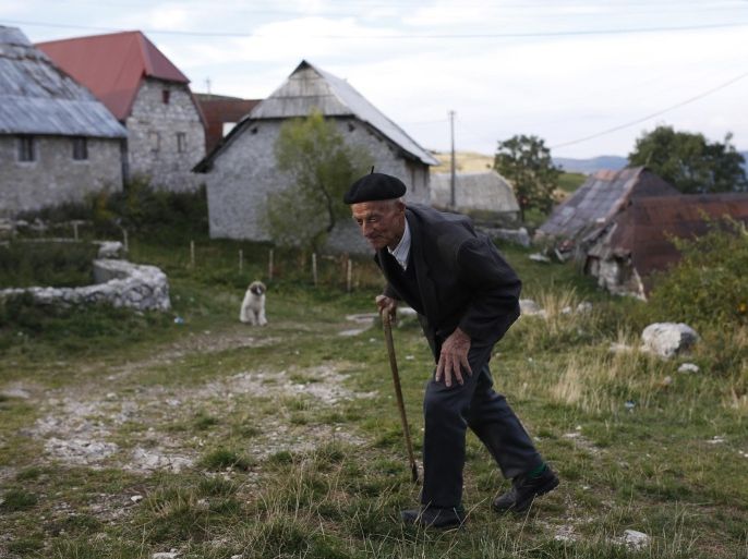 An elderly Bosnian Muslim man walks to the mosque to celebrate the Muslim holiday of Eid al-Adha, in the remote mountain village of Lukomir, 50 kms south of Sarajevo, on Thursday, Sept. 24, 2015. Bosnian Muslims will slaughter cattle later, with the beef and meat distributed to the needy for the holiday which honors the prophet Abraham for preparing to sacrifice his son on the order of God, who was testing his faith.(AP Photo/Amel Emric)