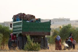 Syrians that fled recent fighting in Aleppo cook near a truck in the southern countryside of Aleppo, Syria October 19, 2015. Fighting in Syria has displaced 35,000 people from Hader and Zerbeh on the southwestern outskirts of the city of Aleppo in the past few days, the U.N. Office for the Coordination of Humanitarian Affairs (OCHA) said on Monday. "Many people are living with host families and in the informal settlements near Kafer Naha and Orem al Kubra in countryside west of the city," a spokeswoman said in an emailed comment, citing reports OCHA had received from the area.REUTERS/Ammar AbdullahFOR EDITORIAL USE ONLY. NO RESALES. NO ARCHIVE.