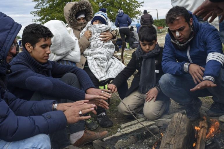 Migrants keep themselves warm around a fire waiting to enter the registration camp after they cross the border between Greece and Macedonia, near the city of Gevgelija, The Former Yugoslav Republic of Macedonia on 21 October 2015. Thousands of migrants continue to arrive in Macedonia on their way to EU countries. Europe is grappling with the biggest migrant influx since World War II, and more than half of those arriving are estimated to be from Syria.