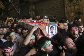 Iranian mourners carry flag the draped coffin of Ali Amraei, who was killed in fighting against Islamic State extremists in Syria, during a funeral ceremony in Shahr-e-Ray, south of Tehran, Iran, Thursday, June 25, 2015. Iranian state media say thousands of people have attended the funerals for eight Iranian volunteers killed in Syria. (AP Photo/Vahid Salemi)