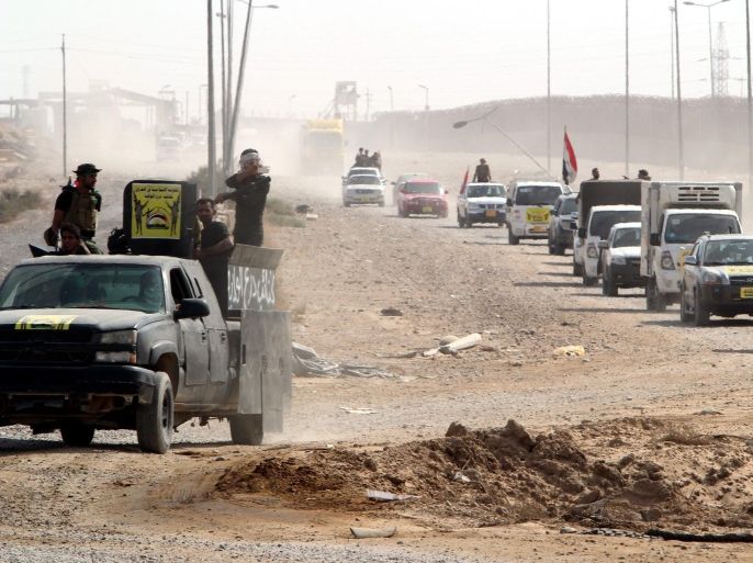 A convoy of volunteers from a Shiite militia move into an area near the the Baiji oil refinery in northern Iraq, on 23 October 2015. According to Iraqi officials Iraqi ground forces backed by Shiite volunteers and airstrikes carried out by the international anti-IS coalition, have liberated the major northern city of Baiji from Islamic State group (IS) militant.
