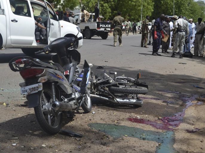 Security officers stand at the site of a suicide bombing in Ndjamena, Chad, June 15, 2015. At least 27 people, including four suspected Boko Haram Islamist fighters, were killed and 100 others were injured on Monday in two attacks in Chad's capital, N'Djamena, which the government blamed on the Nigerian militant group. REUTERS/Moumine Ngarmbassa