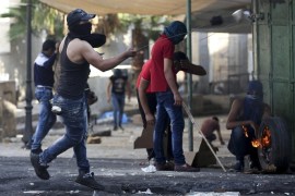 Palestinian protesters throw stones during clashes in the West Bank Hebron, 17 October 2015. Israeli army report about two stabbing attacks against soldiers in Hebron earlier today carried out by a Palestine man and woman, both reported killed by the Israeli army.