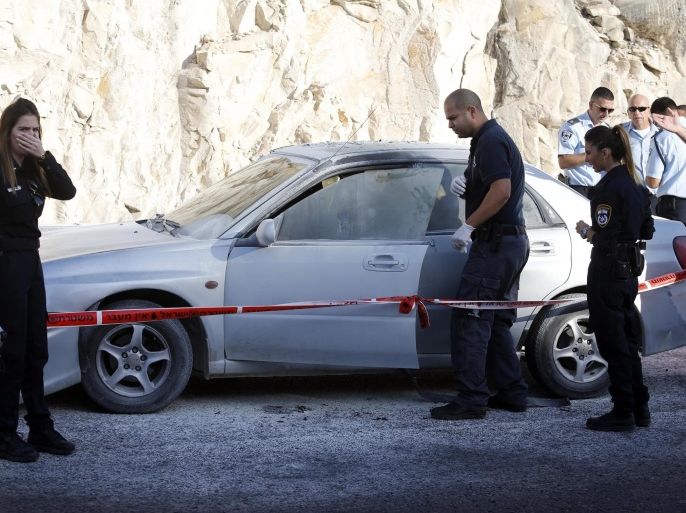 Israeli police work at the scene after a Palestinian women reportedly activated an explosive device near a-Zaim checkpoint, West Bank, on a road leading from the Jewish settlement of Ma'ale Adumim to Jerusalem, Israel, 11 October 2015. According to Israeli police, a car bomb injured a police officer and the Palestinian driver of the vehicle. The woman had been asked to step out of a car after it was spotted moving suspiciously by police.