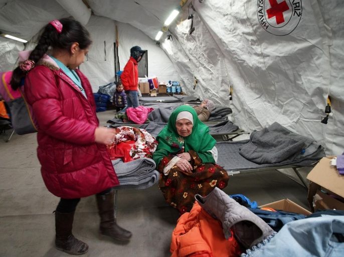 105-year old Afghan woman refugee Bibihal Uzbeki from Kunduz, Afghanistan, rests in Croatia's main refugee camp at Opatovac, Croatia, near the border with Serbia, Tuesday, Oct. 27, 2015. Centenarian Bibihal Uzbeki, crossed into Croatia on a stretcher from Serbia with a large group of refugees, including her son and several other relatives, among tens of thousands who have traveled across continents, fleeing war and poverty to search for a happier, safer future in Europe. (AP Photo/Marjan Vucetic)