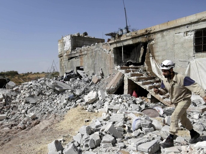A civil defence member walks on the rubble of a damaged building next to a site hit by what activists said were airstrikes carried out by the Russian air force at Ehsim town in the southern countryside of Idlib, Syria October 3, 2015. REUTERS/Khalil Ashawi