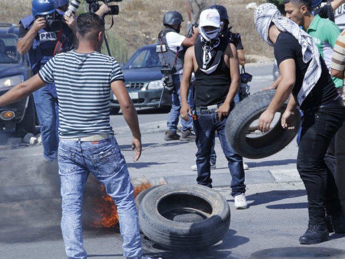 ‪الشباب يضرمون النيران في الإطارات ويغلقون الطرق‬ (الجزيرة)