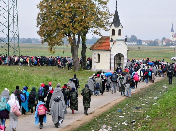 Migrants walking from Rigonce to the refugees center in Dobova, Slovenia, 23 October 2015. Thousands of refugees kept streaming into Slovenia 22 October 2015, straining the small country's resources and its patience with other EU nations that have been passing on migrants who want to reach Western Europe. Slovenia has become the latest country to come under pressure from Europe's migration crisis. More than 680,000 migrants and refugees have arrived on the continent by sea this year, the biggest population movement it has experienced since World War II.