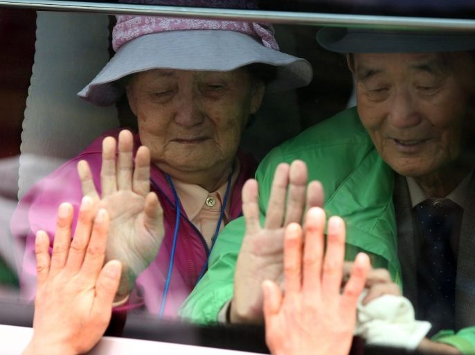 South Koreans on a bus place their hands on the windows to greet their North Korean relatives as they bid farewell on the last day of separated families reunions on Mount Kumgang, on North Korea's east coast, 26 October 2015. About 260 South Koreans arrived at the resort two days ago for the first face-to-face reunion of families separated by the 1950-53 Korean War in nearly 20 months. A prior group of some 390 South Koreans did the same for three days starting on 20 October. EPA/KPPA / POOL SOUTH KOREA OUT