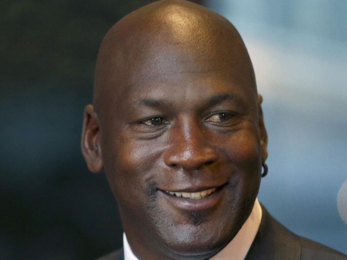 Michael Jordan smiles at reporters after a jury ordered a defunct grocery store chain to pay him $8.9 million for using his name without permission. Friday, Aug. 21, 2015, in Chicago. Jurors had to calculate how much the now-defunct grocery chain Dominick's Finer Foods should pay Jordan for invoking his name in an ad without permission. They sent one note to the judge, saying: "We need a calculator." (AP Photo/Charles Rex Arbogast)