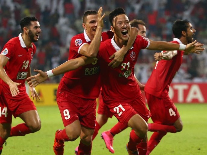 Kwon Kyung-Won (C) of UAE's Al-Ahli celebrates after scoring a third goal against Saudi's Al-Hilal during their AFC Champions League semi final football match on October 20, 2015 in Dubai. AFP PHOTO / MARWAN NAAMANI