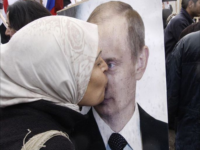 A Syrian woman kisses a poster of Russian President Vladimir Putin during a pro-Syrian government protest in front of the Russian Embassy in Damascus Syria. AP Photo Muzaffar Salman File