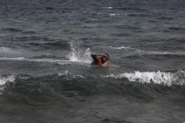A man swims towards the shore as refugees and migrants arrive at the island of Lesvos after crossing the Aegean see from Turkey, Greece, 08 October 2015. An estimated 100,000 refugees and migrants arrived on the Greek islands during August, according to the Hellenic Coast Guard. A recently agreed European Union plan to relocate tens of thousands of asylum seekers from Italy and Greece elsewhere in the bloc will start at the end of this week, a top EU official said 06 October. EPA/YANNIS KOLESIDIS GREECE OUT