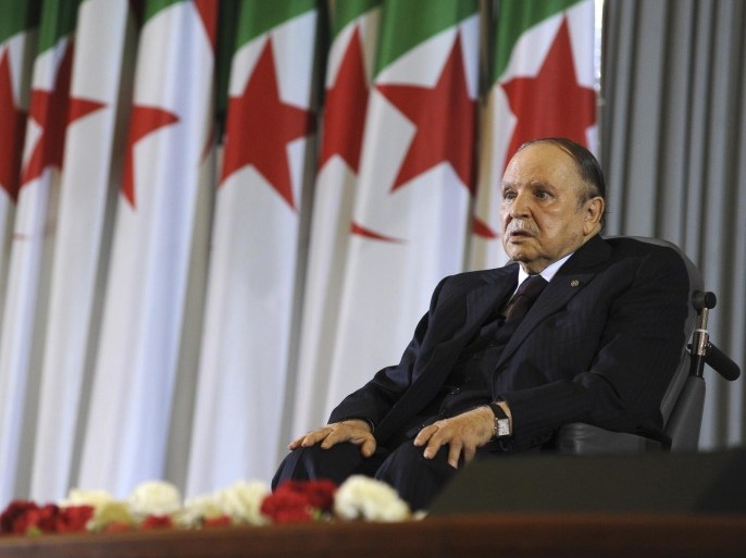 FILE - In this April 28, 2014 file photo, Algerian President Abdelaziz Bouteflika, sitting in a wheelchair, listens after taking the presidential oath in Algiers. Algeria is in the grips of political intrigue, as the president nears death and rumors of coup attempts swirl. Now, the unprecedented firing of three top generals is generating fear that a power struggle within the regime will break into the open - unleashing a new cycle of the bloodshed that plagued the country in the 1990s. (AP Photo/Sidali Djarboub, File)