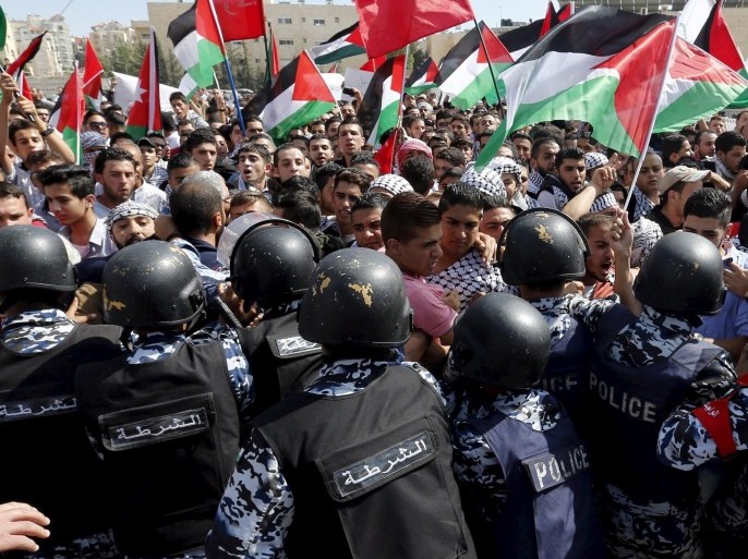 Protesters scuffle with riot policemen during a protest to express solidarity with Palestinians and against the escalation of Israeli-Palestinian violence near the Israeli Embassy in Amman, Jordan October 9, 2015. Clashes between protesters and police erupted in Amman on Friday during a demonstration against violence surrounding events at the al-Aqsa mosque compound in Jerusalem's Old City. REUTERS/Muhammad Hamed