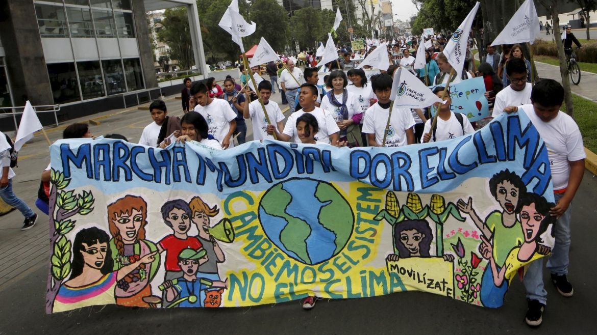 Students holding a banner take part in a rally ahead of the 2015 Paris Climate Change Conference (COP21), in Lima, Peru, November 29, 2015.  REUTERS/Mariana Bazo