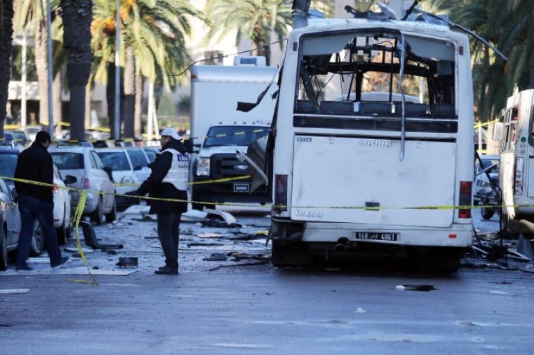 Tunisian forensic police inspect the wreckage of a bus in the aftermath of a bomb attack on a bus transporting Tunisia's presidential guard in Tunis,Tunisia 25 November 2015.At least thirteen people are known to have been killed