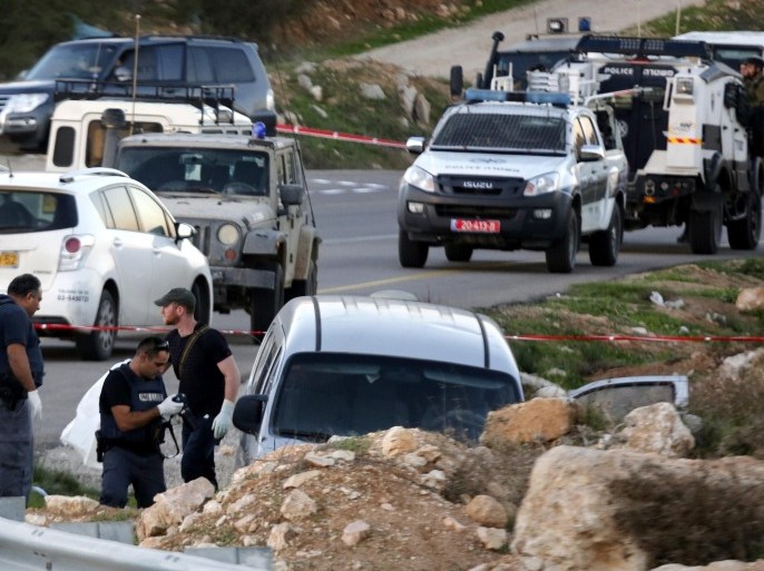 Israeli soldiers inspect the scene after an Israeli car came under fire from an alleged passing Palestinian vehicle, near the Israel settlement of Athniel, south of the West Bank city of Hebron, 13 November 2015. Israel army report that two Israeli's were killed, a father and his son, and one injured when shots were fired at their vehicle near Hebron, the attacker fled the scene. Istaeli forces are currently searching the area.