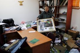 A man carries a photo inside the offices of the The Islamic Movement northern branch in Israel after Israel outlawed the Movement today in Umm al-Faham, northern Israel, November 17, 2015. Israel on Tuesday outlawed an Islamist group it says has played a central role in stirring up violence over a Jerusalem holy site in a wave of bloodshed that began seven weeks ago. The decision by Israel's security cabinet, accompanied by police raids on the offices of the Islamic Movement's northern branch, were some of the strongest actions in years against a prominent organisation of the country's Arab minority. REUTERS/Ammar Awad
