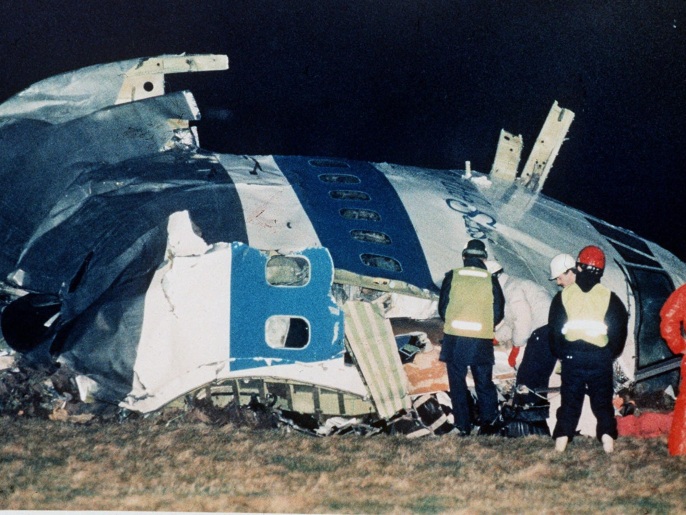FILE - In this Dec. 21, 1988, file photo, rescue workers examine the nose of Pan Am Flight 103 near the town of Lockerbie, Scotland, after a bomb aboard exploded, killing a total of 270 people. Families of some of the 270 people who died in the airliner bombing 25 years ago gathered for memorial services Saturday, Dec. 21, 2013, in the United States and Britain, honoring victims of the terror attack that killed dozens of American college students and created instant havoc in the Scottish town where wreckage of the plane rained down. (AP Photo/Martin Cleaver, File)