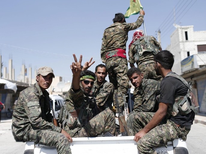 Members of Kurdish People Defence Units (YPG) flash victory sign after coming from Syrian town of al-Raqqa, in Tel Abyad, Syria, 23 June 2015. Kurdish fighters backed by US-led airstrikes captured a strategic town from Islamic State on 23 June as they pushed towards the extremist group's Syrian heartland. The Kurdish People's Protection Units (YPG) and allied rebels took complete control of the town of Ain Issa, bringing them within 50 kilometres of Islamic State's de facto Syrian capital of al-Raqqa, the Syrian Observatory for Human Rights said.