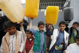 Boys hold up jerrycans to represent drinking water during a protest against a Saudi blockade of Yemen's ports, outside the United Nations' offices in Sanaa, Yemen October 19, 2015. U.N.-sponsored talks to end months of fighting in Yemen will convene in Geneva at the end of October, the U.N. special envoy for the issue has announced, urging the parties to try to make the negotiations a success. At least 5,400 people have been killed in the six-month civil war in the poorest country on the Arabian Peninsula, and the United Nations says the humanitarian situation, exacerbated by a Saudi blockade of Yemen's ports, is "critical". REUTERS/Khaled Abdullah
