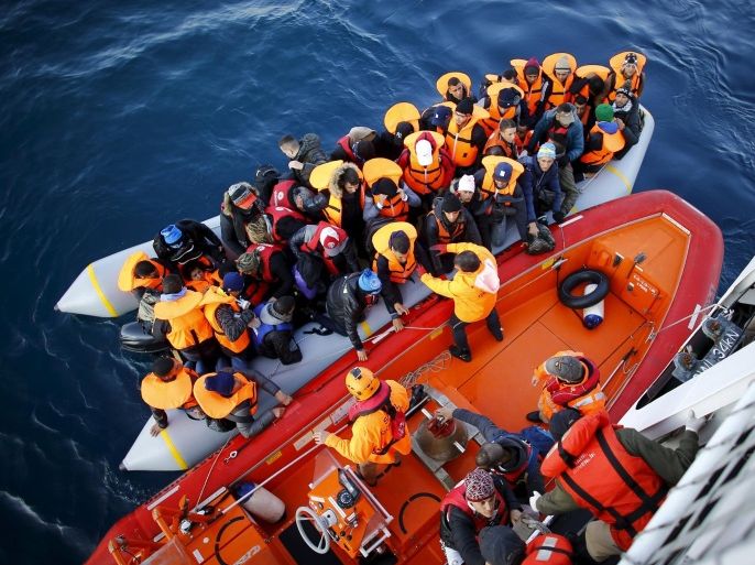 Refugees and migrants board the Turkish Coast Guard Search and Rescue ship Umut-703, off the shores of Canakkale, Turkey, after a failed attempt at crossing to the Greek island of Lesbos, November 9, 2015. REUTERS/Umit Bektas